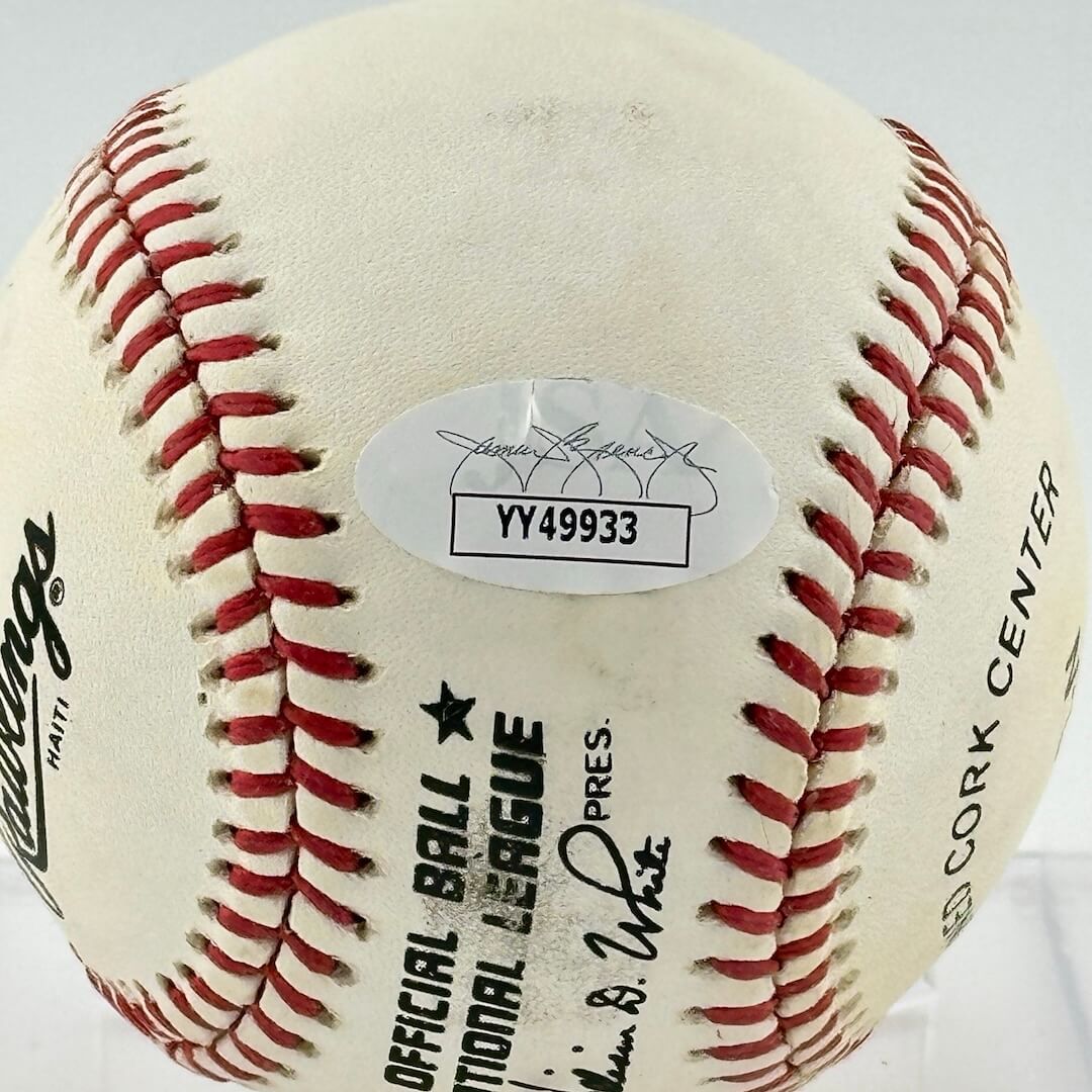 Close up of JSA authentication sticker next to MLB ball information stamp.