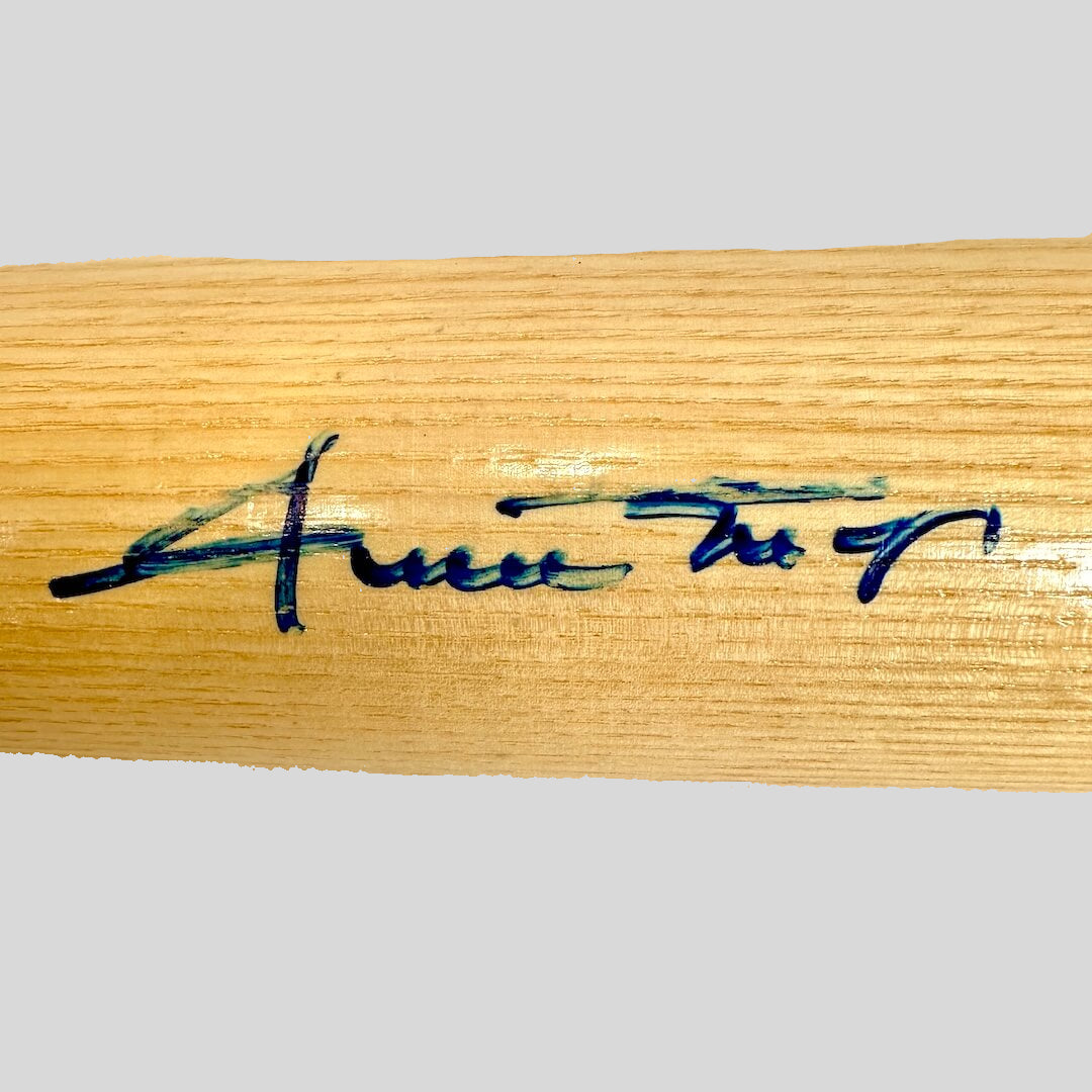 Wooden bat with a signature on a white background