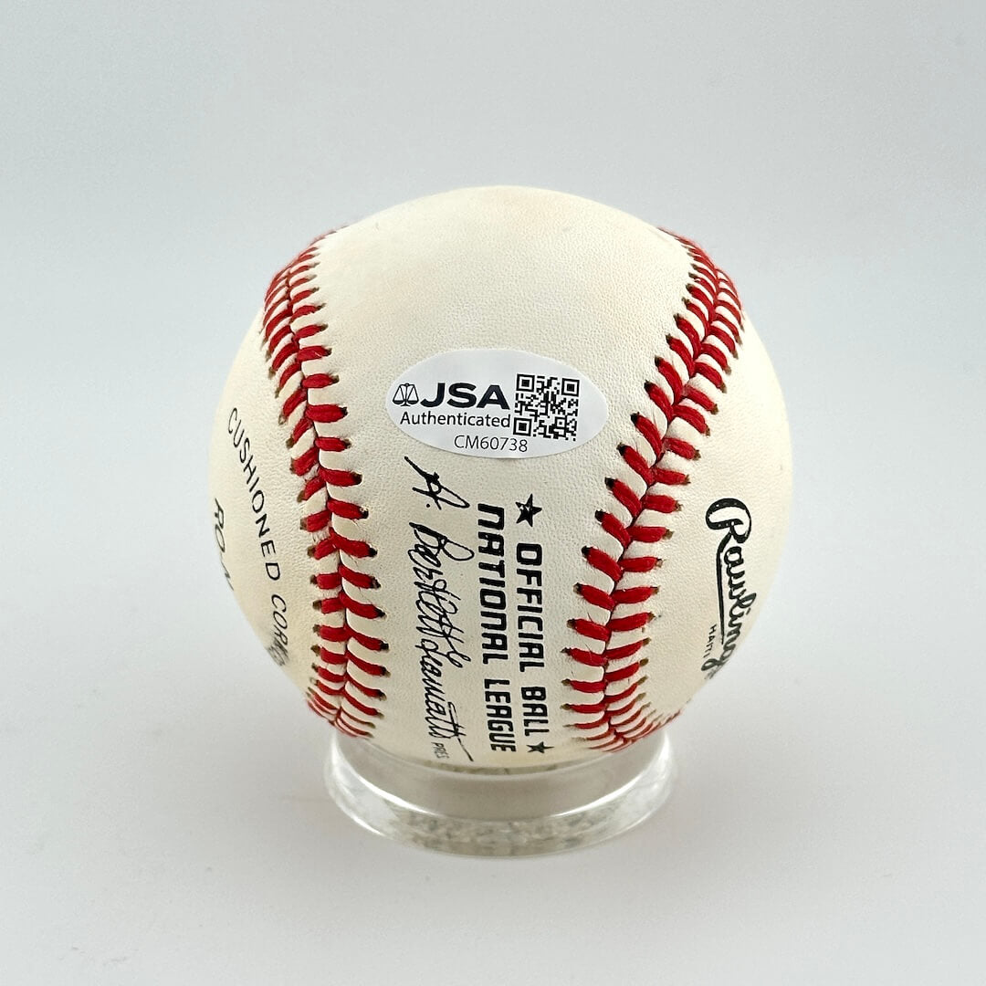 Baseball with JSA authentication label on a white background