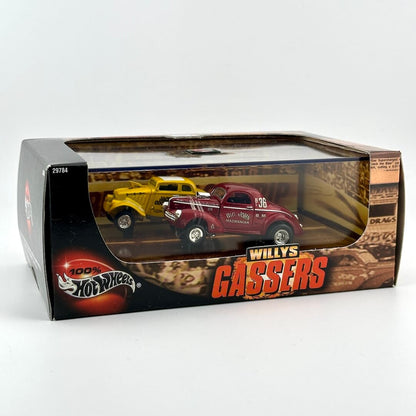Hot Wheels Gassers diecast model cars in their original window box packaging, featuring a yellow car and a red car.