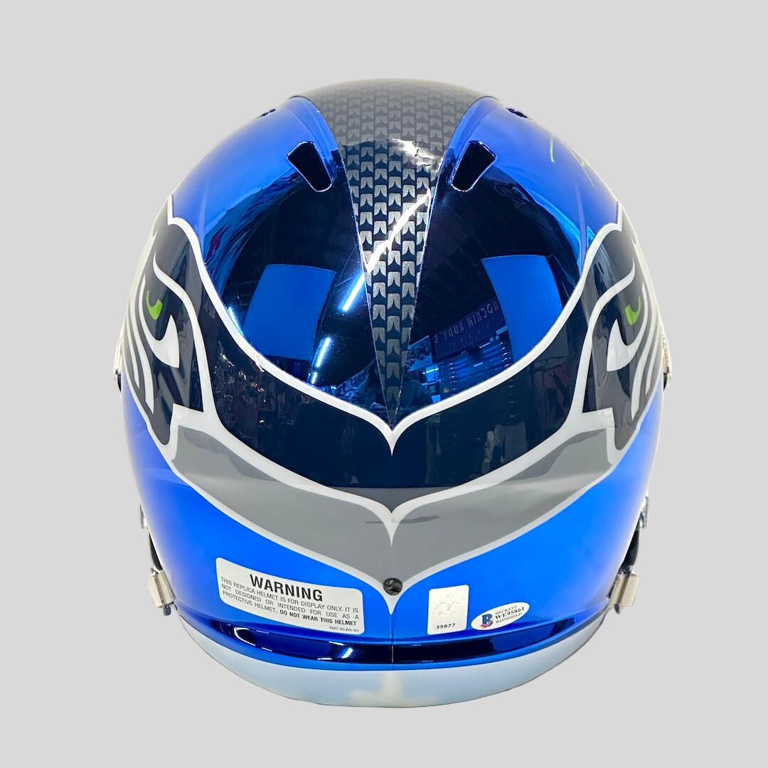 Blue football helmet with Seattle branding against white background. 