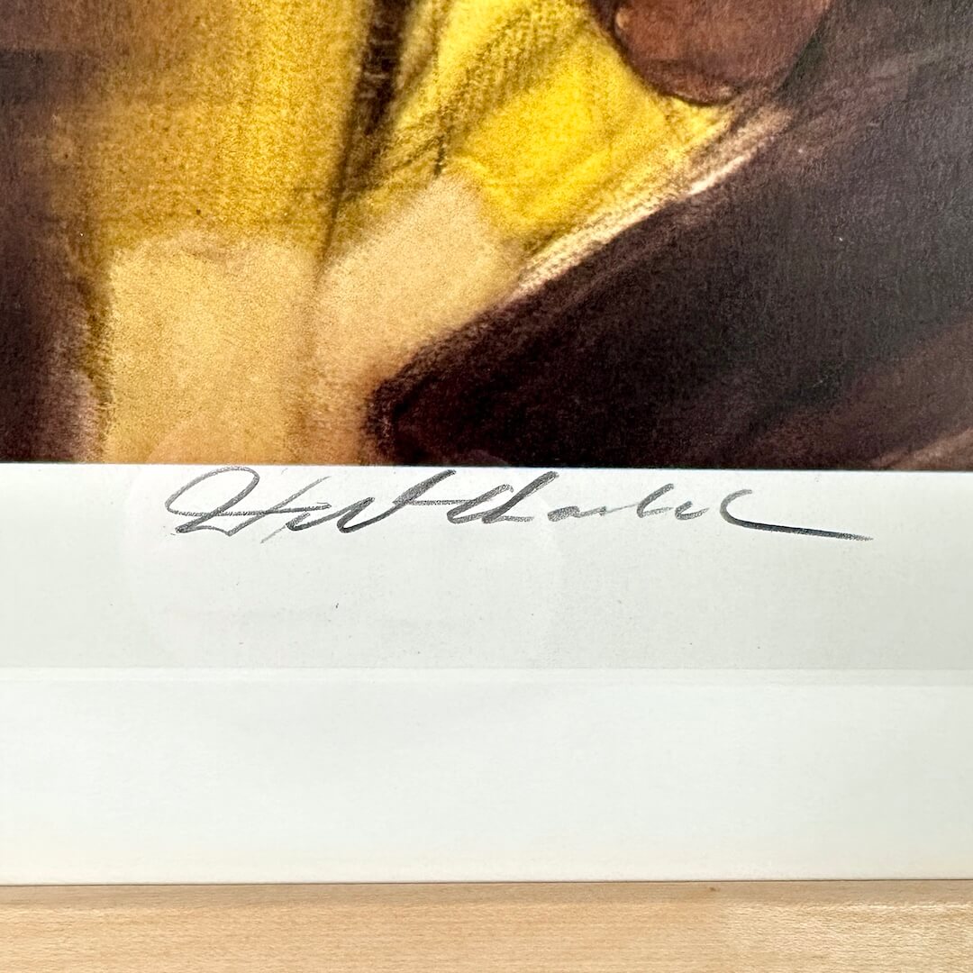 Close-up of a signature on a piece of paper with a blurred background
