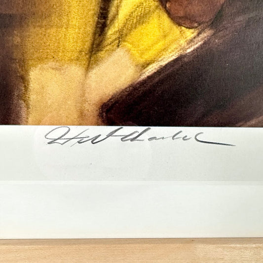 Close-up of a signature on a piece of paper with a blurred background