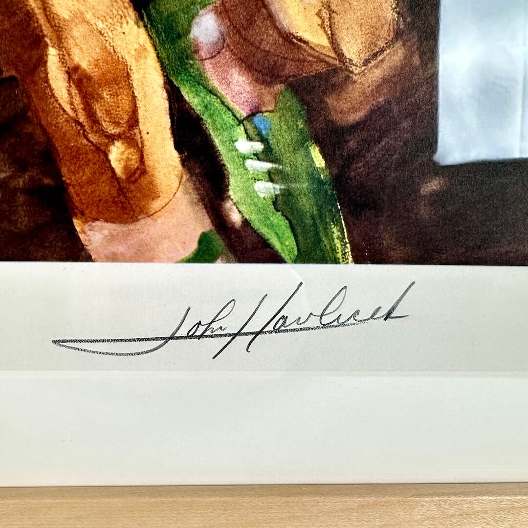 Close-up of a signature on a piece of paper with a blurred background