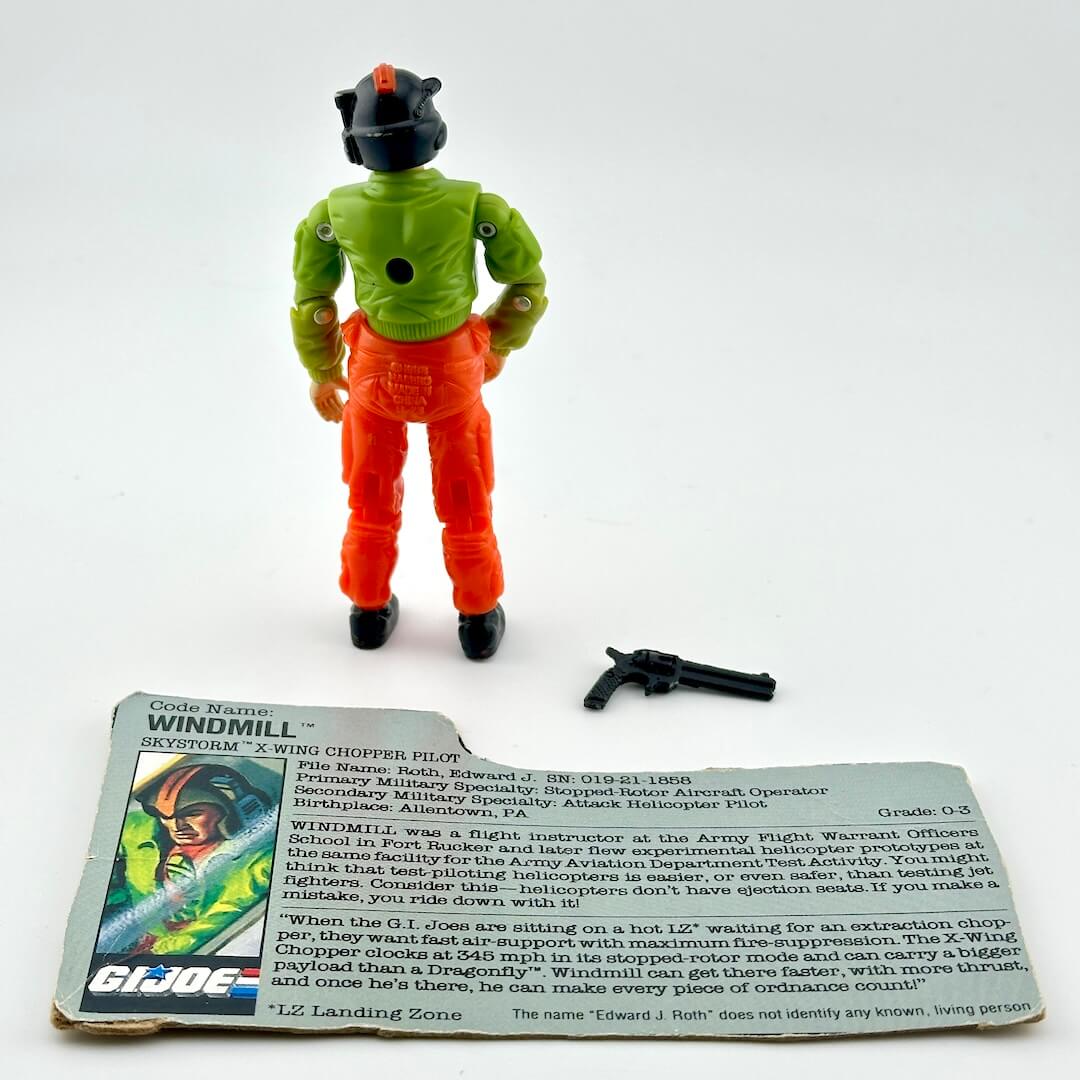 Action figure with accessory and character card against white background.