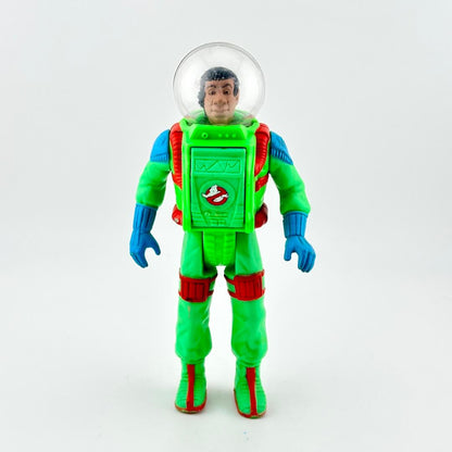 Toy figure in a green astronaut suit with a clear helmet on a white background