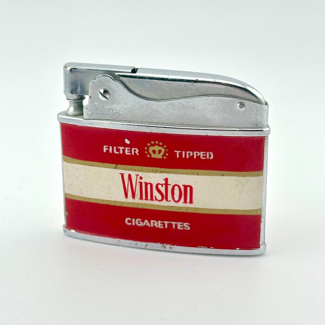 A novelty lighter featuring a red and cream striped design with the brand name 'Winston' and a silver metal top.