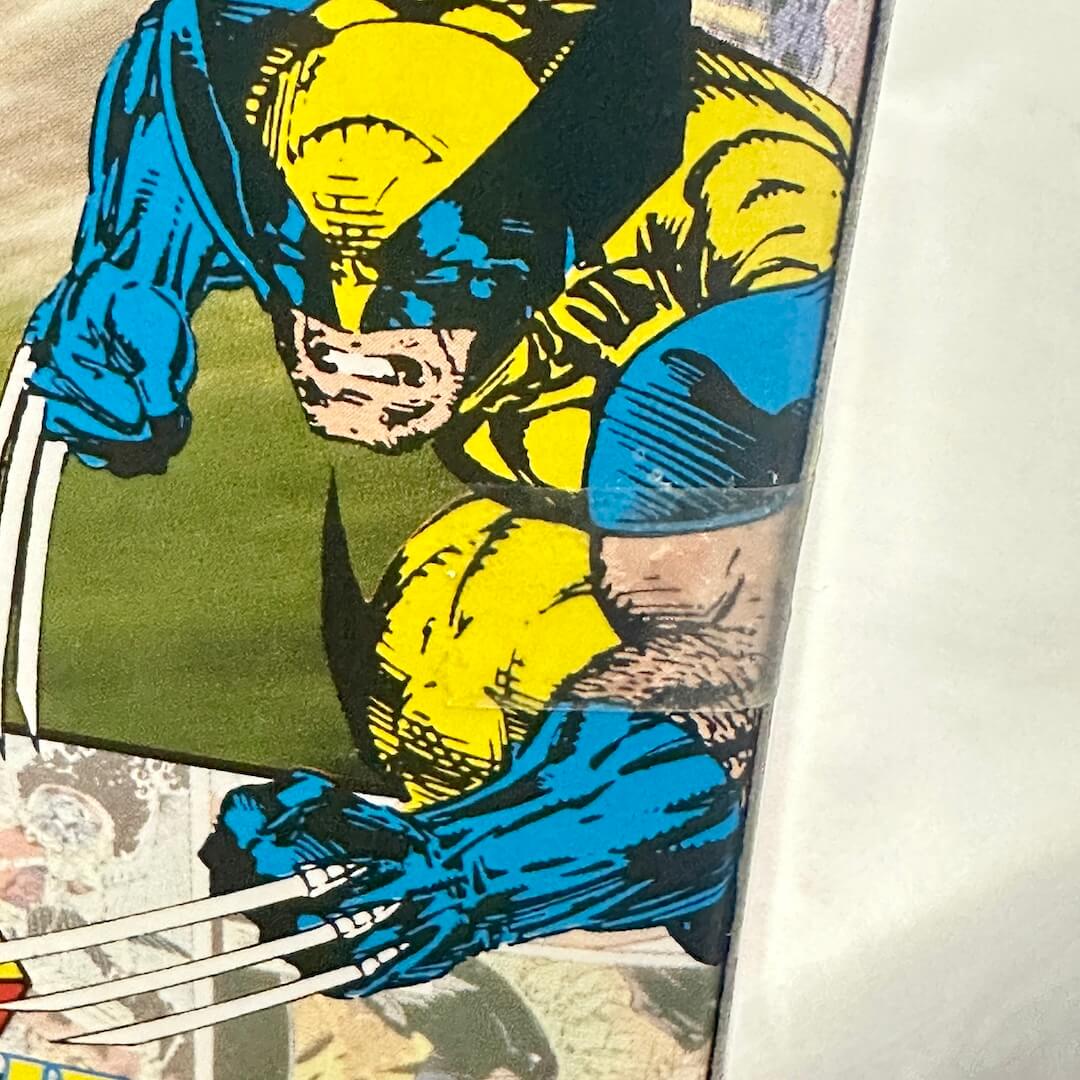 Comic book panel featuring a superhero in blue and yellow costume with claws.
