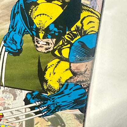 Comic book panel featuring a superhero in blue and yellow costume with claws.