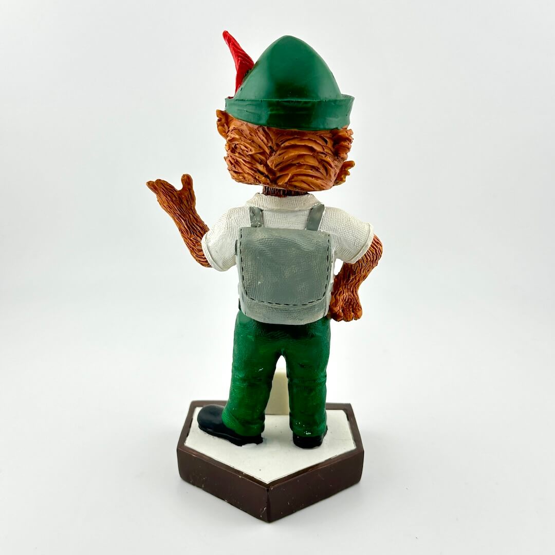 Bobblehead figure of a character with a green hat and brown outfit on a white background