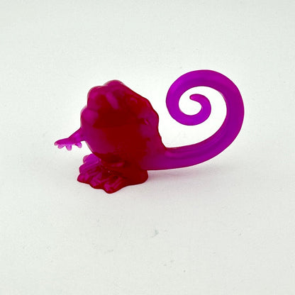 Purple and red object with a spiral design on a white background