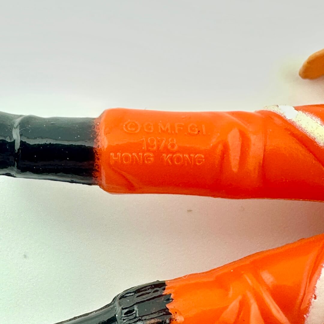 Close-up of COO and copyright information on the back of the leg of the figure. 