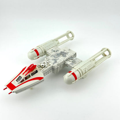 Toy model of a spaceship with red accents on a white background