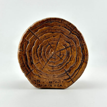 Ceramic bank made to look like wooden cross section. Copyright info along bottom.