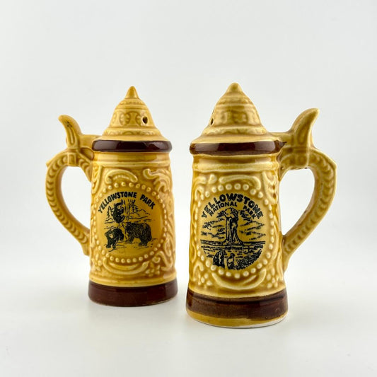 Two ceramic steins with Yellowstone National Park design on a white background