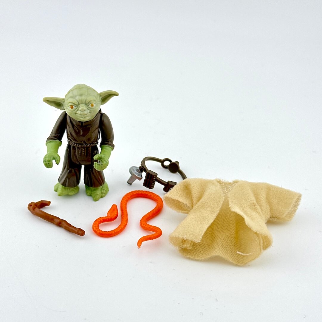 Yoda action figure with accessories on white background.