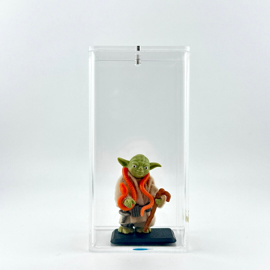 Yoda action figure on stand in clear display case.