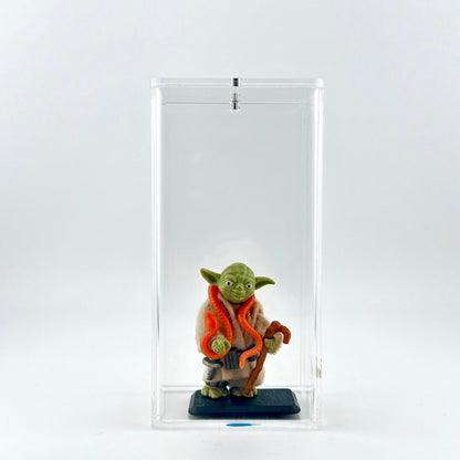 Yoda action figure on stand in clear display case.