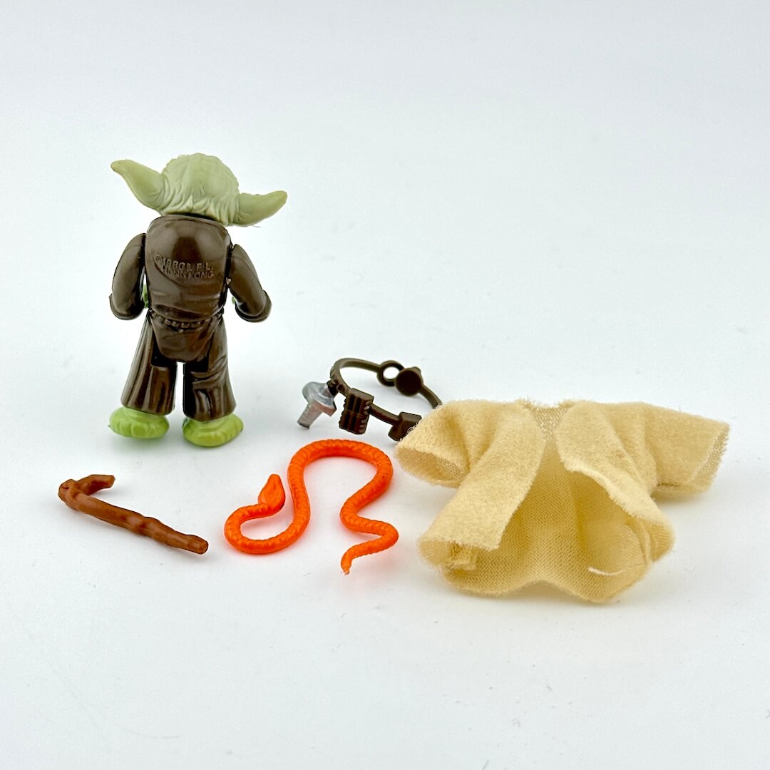 Yoda action figure with accessories on white background.