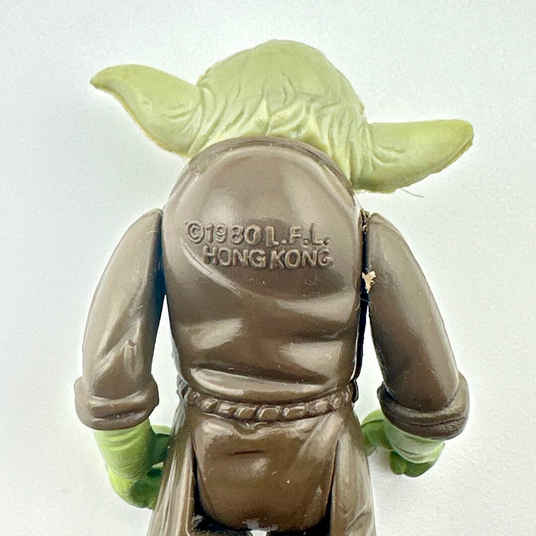 Back view of a Yoda figure with '1980 L.F.L. Hong Kong' text on the back.