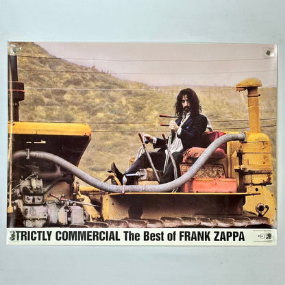 Album cover with Frank Zappa sitting on a large piece of machinery against a mountainous background.