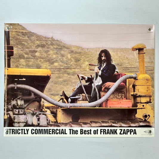 Album cover with Frank Zappa sitting on a large piece of machinery against a mountainous background.