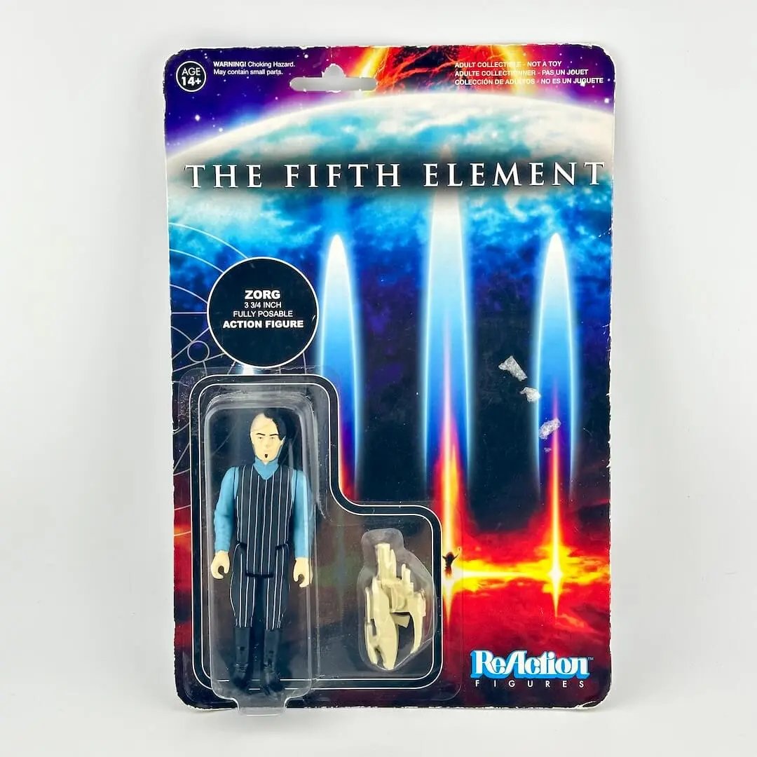 A Fifth Element action figure in its original blister packaging; figure in pinstripe suit with blue shirt. 