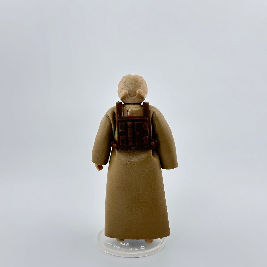 Image of 3.5 inch action figure in beige cloak, brown utility bag on back, & wrinkly alien head detail