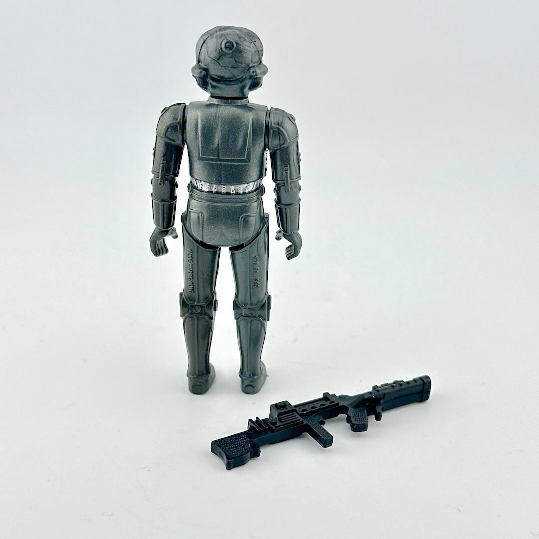 Toy figure of a robot with a weapon on a white background