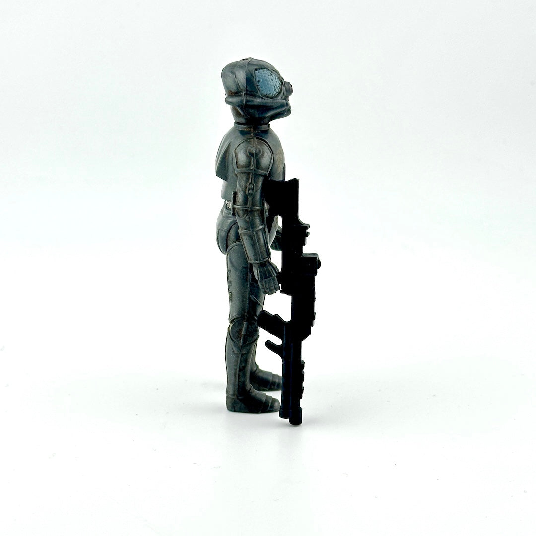 Action figure of gray cyborg holding big black gun against white background. 