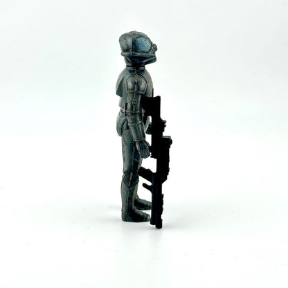 Action figure of gray cyborg holding big black gun against white background. 